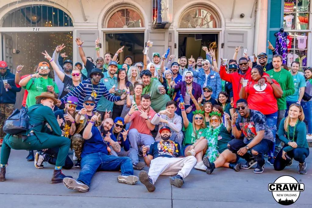A group of people enjoying drinks at a New Orleans bar in the French Quarter